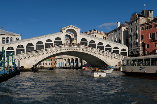 Venice, Italy - Febuary 21, 2020: boats and the Rialto bridge on the Grand Canal in Venice, Italy on Febuary 21, 2020