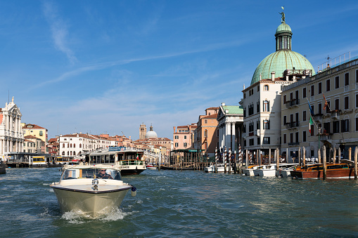 VENICE, ITALY - FEBRUARY 22, 2020: Grand Canal with boats. Grand Canal forms one of the major water-traffic corridors in the city of Venice