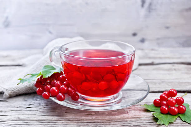 istock Tea from viburnum in cup with berries on gray wooden board 1216595334