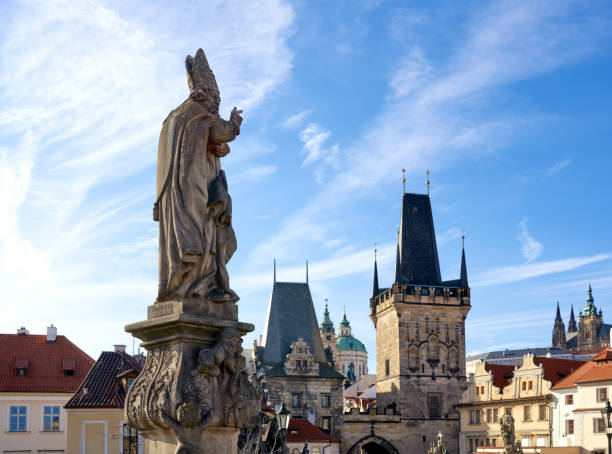 Prague, Czech Republic - March 2, 2020  Charles Bridge with baroque statue and Lesser town bridge towers