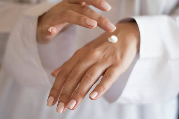 Beautiful woman hands with cream stock photo
