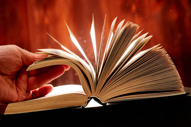 istock Turn over a thick book. Search for information in a book. Learning concept. 1216599799