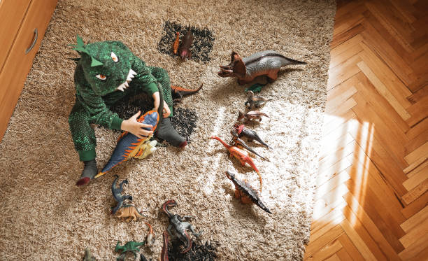 istock Toddler playing with his dinosaurs 1216600018