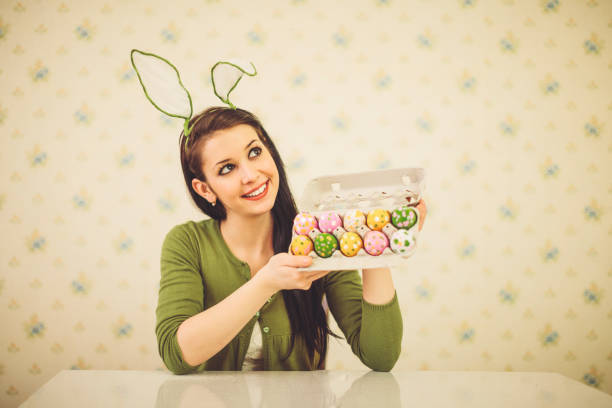 Easter bunny girl showing her painted eggs