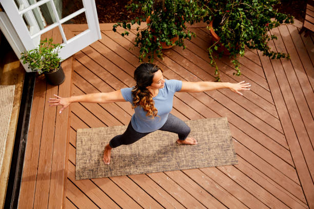 istock Mature woman practicing her warrior pose outside 1216602851