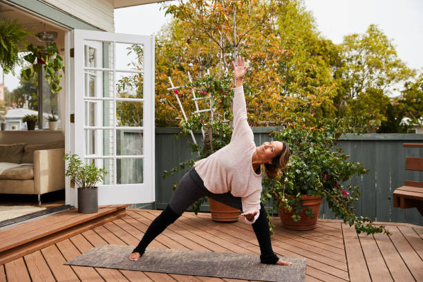 istock Mature woman practicing yoga alone on her patio 1216603230