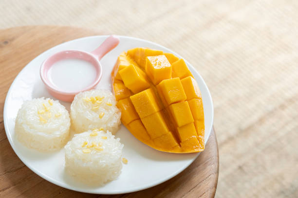 istock Mango tropical fruit and sticky rice with coconut juice. Thai dessert. 1216604398