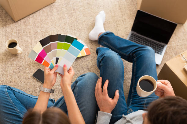 istock Couple choosing paint colour for their new home 1216604754