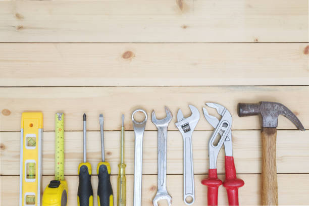 istock Tools set on wood table. screwdriver, tape measure, hammer and wrench. 1216604965