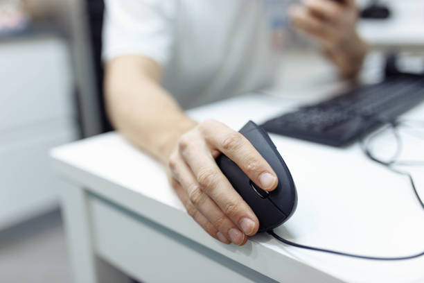 istock In the man’s hand, a vertical ergonomic computer mouse-joystick is used. 1216606373