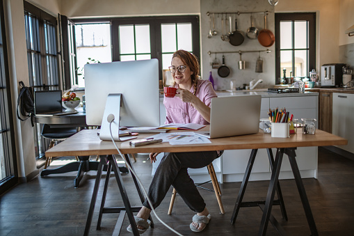 Beautiful young woman working from home in days of isolation, she having Video Conference at home