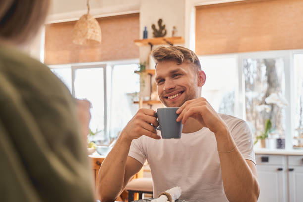 istock Cheerful young man listening to his girlfriend 1216609923