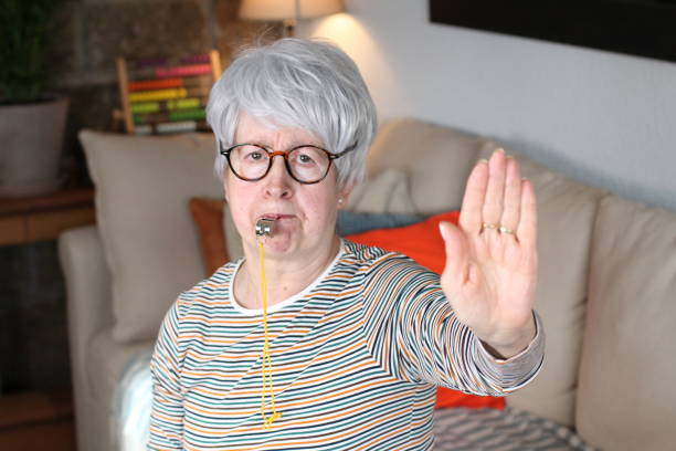 istock Senior woman blowing a whistle 1216610659