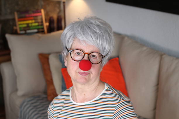 istock Senior lady with clown nose 1216610898