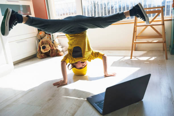 Little boy dancing break at home. Headstand. Home Pleasures. E-learning