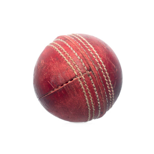 istock Old red leather cricket ball isolated against a white background 1216611658