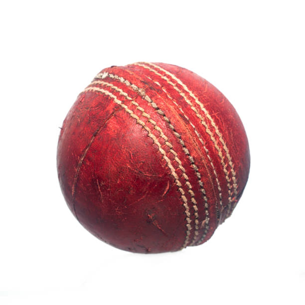 istock Old red leather cricket ball isolated against a white background 1216611776
