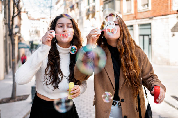 istock Two young caucasian women blowing bubbles 1216611813