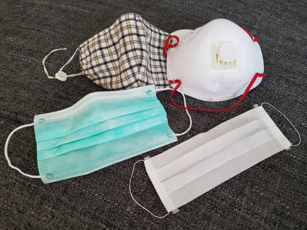 istock Four different variants or kind of face mask - for example surgical mask in green , ff3 breathing mask with high standard , fabric self needled used as illness protection in medical practice and hospitals by doctors and nurse -e.g. corona virus / covid-19 1216611922