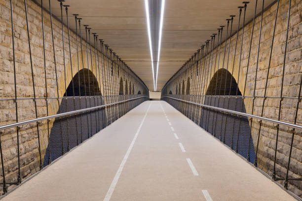 Illuminated cycle track below Pont Adolphe bridge Luxembourg city Illuminated cycle track below Pont Adolphe bridge in Luxembourg city petrusse stock pictures, royalty-free photos & images