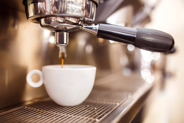 istock Coffee machine preparing fresh coffee and pouring into cups at restaurant, bar or pub. 1216612120