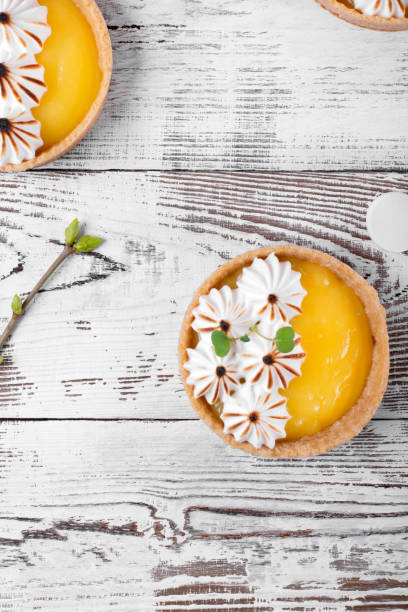 мини пироги с лимонным творогом и карамелизированным безе на белом деревянном столе - lemon meringue pie pie pastry crust portion стоковые фото и изображения