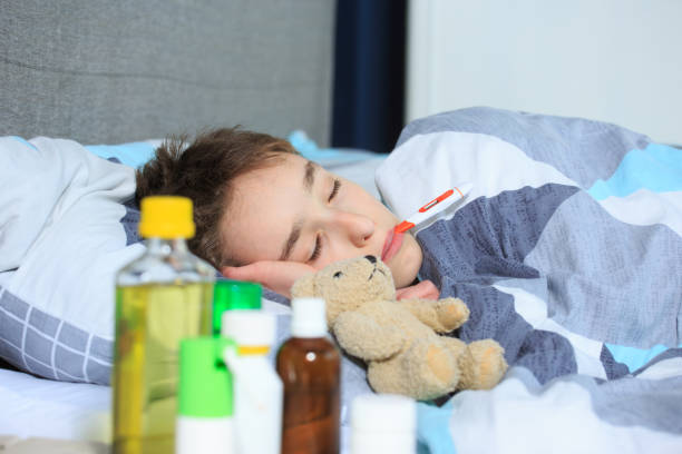 istock Flue and fever , Sick child , sick kid lying in bed with 1216614682