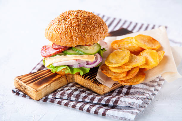 istock Hamburger and potatoes slices on a table, selective focus, copy space 1216614808