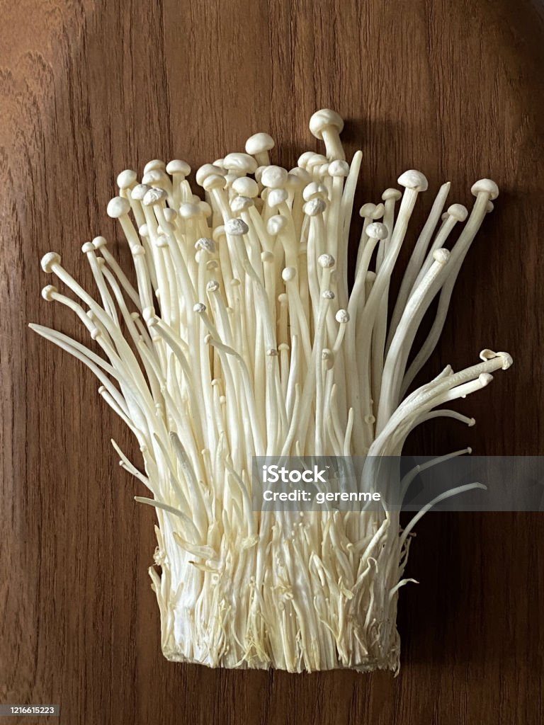 mushrooms Pile of mushrooms on a wooden background Enoki Mushroom Stock Photo