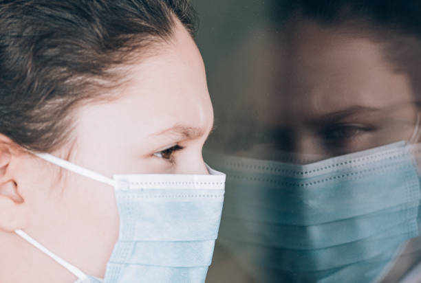 istock Young girl wearing face mask 1216616375