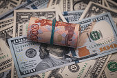 financial concept, the volatility of the Russian economy, the dynamics of fluctuations of the ruble, a roll of five thousandth bills lie on dollars