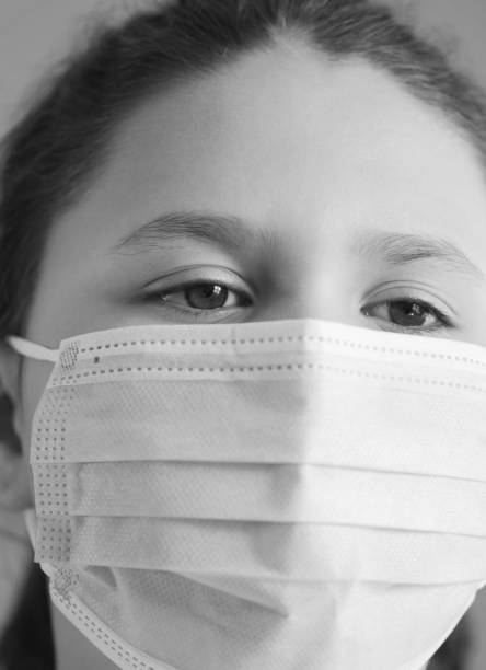 istock Young girl wearing face mask 1216616444