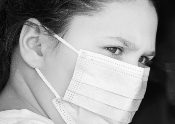 istock Young girl wearing face mask 1216616467