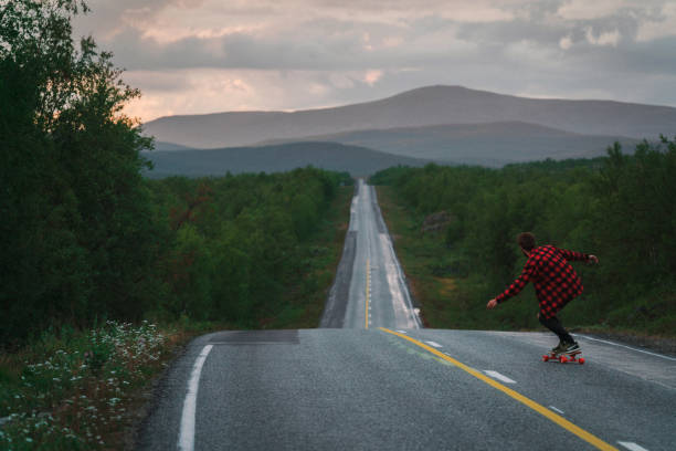 istock Man longboarding  on the road in Finland 1216619202