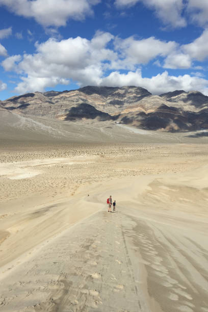 istock Two men walking along a sand dune at Eureka Dunes in Death Valley 1216620804