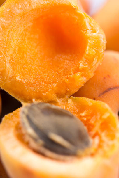 istock Closeup macro opened fresh apricots in the bowl. 1216622547