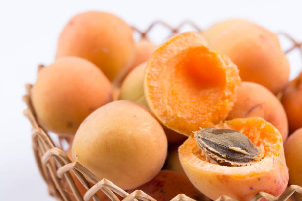Closeup macro opened fresh apricots in the bowl