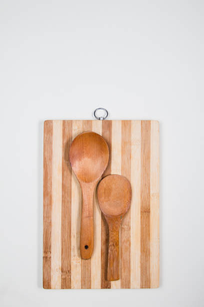 istock Wooden cutting board with wooden spoons on a table 1216623349