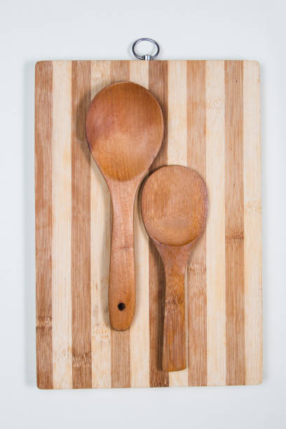 istock Wooden cutting board with wooden spoons on a table 1216623402