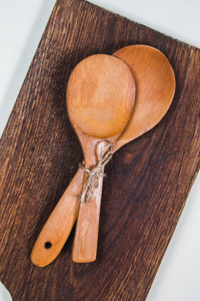 istock Wooden cutting board with wooden spoons on a table 1216623455