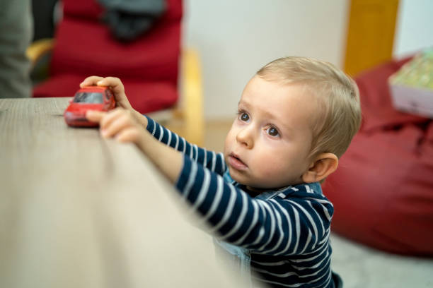 istock Adorable happy boy sitting on the floor. 1216624384