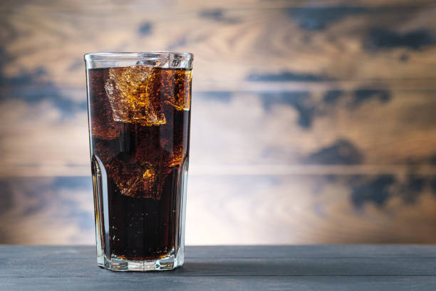 istock Full glass drink cola with ice cubes. Soda with bubbles 1216628309
