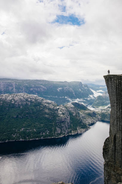 istock Hiker enjoying the view from Preikestolen, The Pulpit Rock. 1216628798