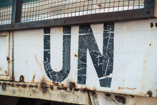 istock UN text on an old rusty car. The United Nations sign, global organization. 1216632670