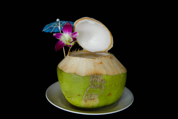 istock coconut juice on black background 1216634619