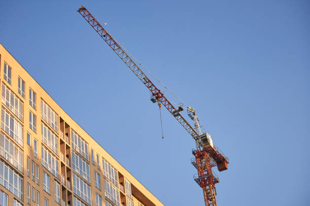 istock Tower crane on the construction site with city building background at sunset 1216634818