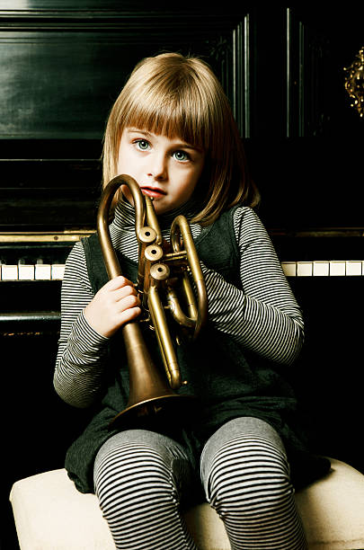 istock Beautiful child holding trumpet 121663593