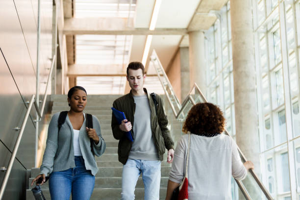 istock College friends descend staircase on campus 1216637614
