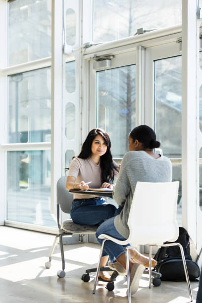 istock Attentive female college student talks with friend 1216637673