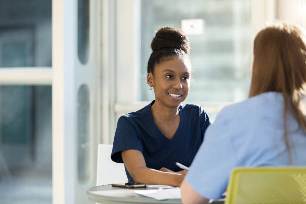 istock Cheerful female medical student studies with friend 1216638562